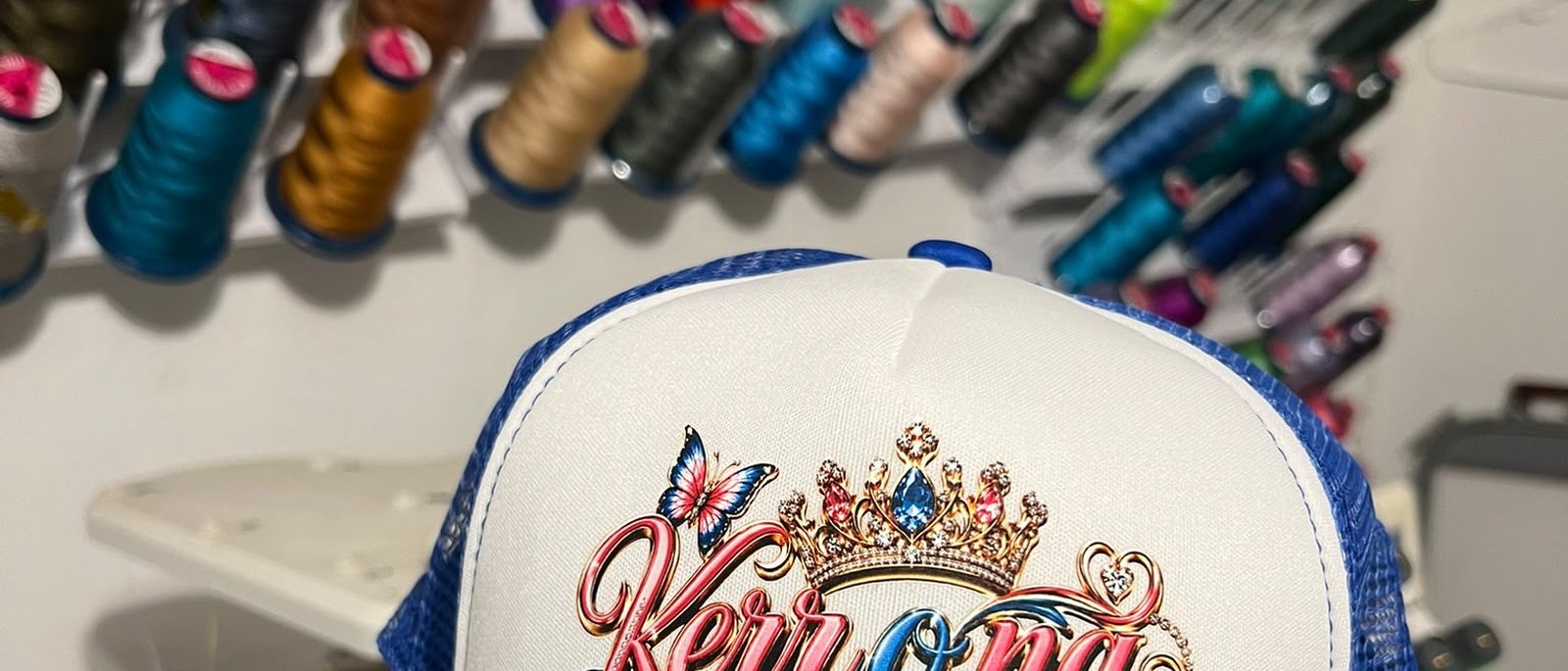 The KiX Creative Studios embroidery thread wall and finished cap work